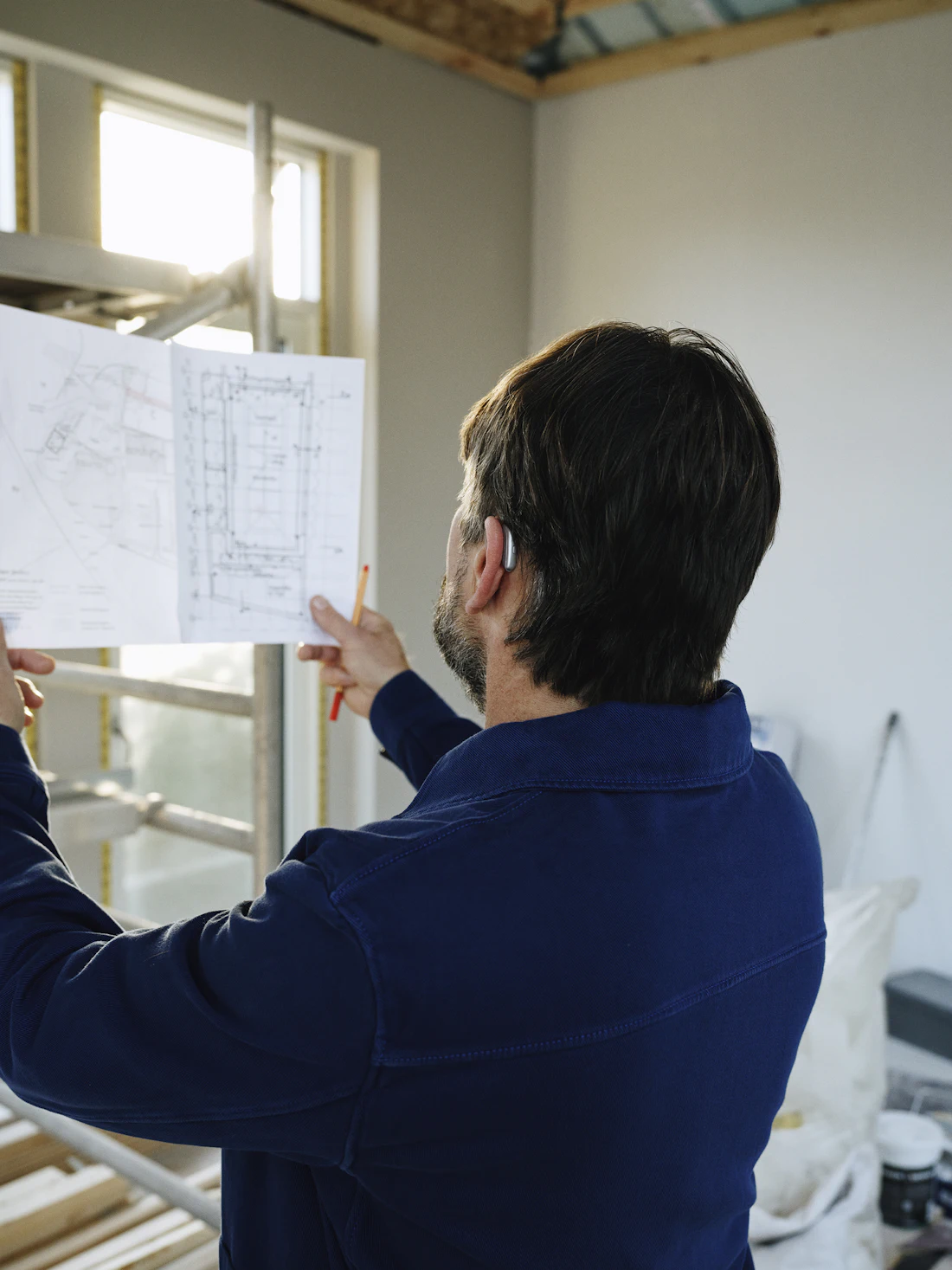 C Six Solutions specialist reviewing project drawings